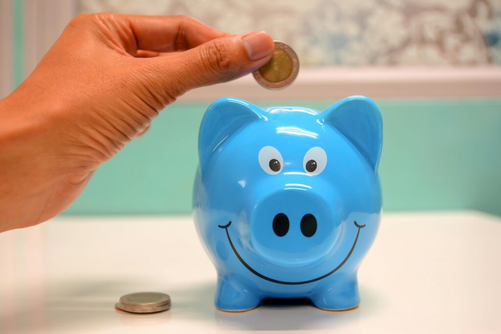 Erasmus student budget saving money with a coin in a piggy bank