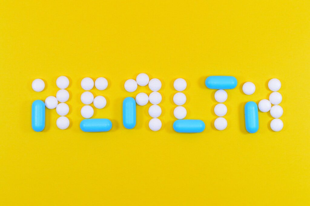 Health and safety tips for students abroad written with pills on a yellow background