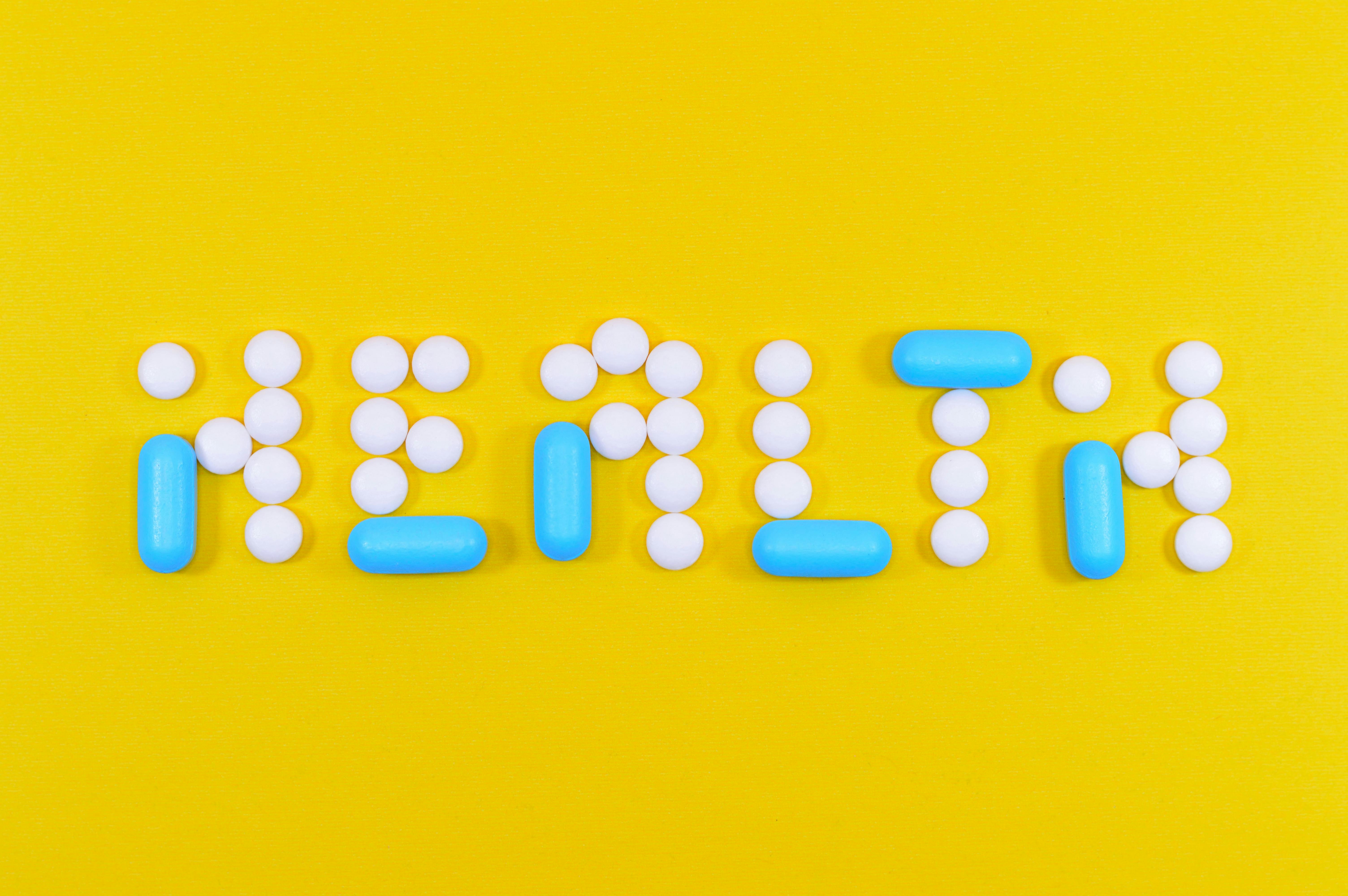 Health and safety tips for students abroad written with pills on a yellow background