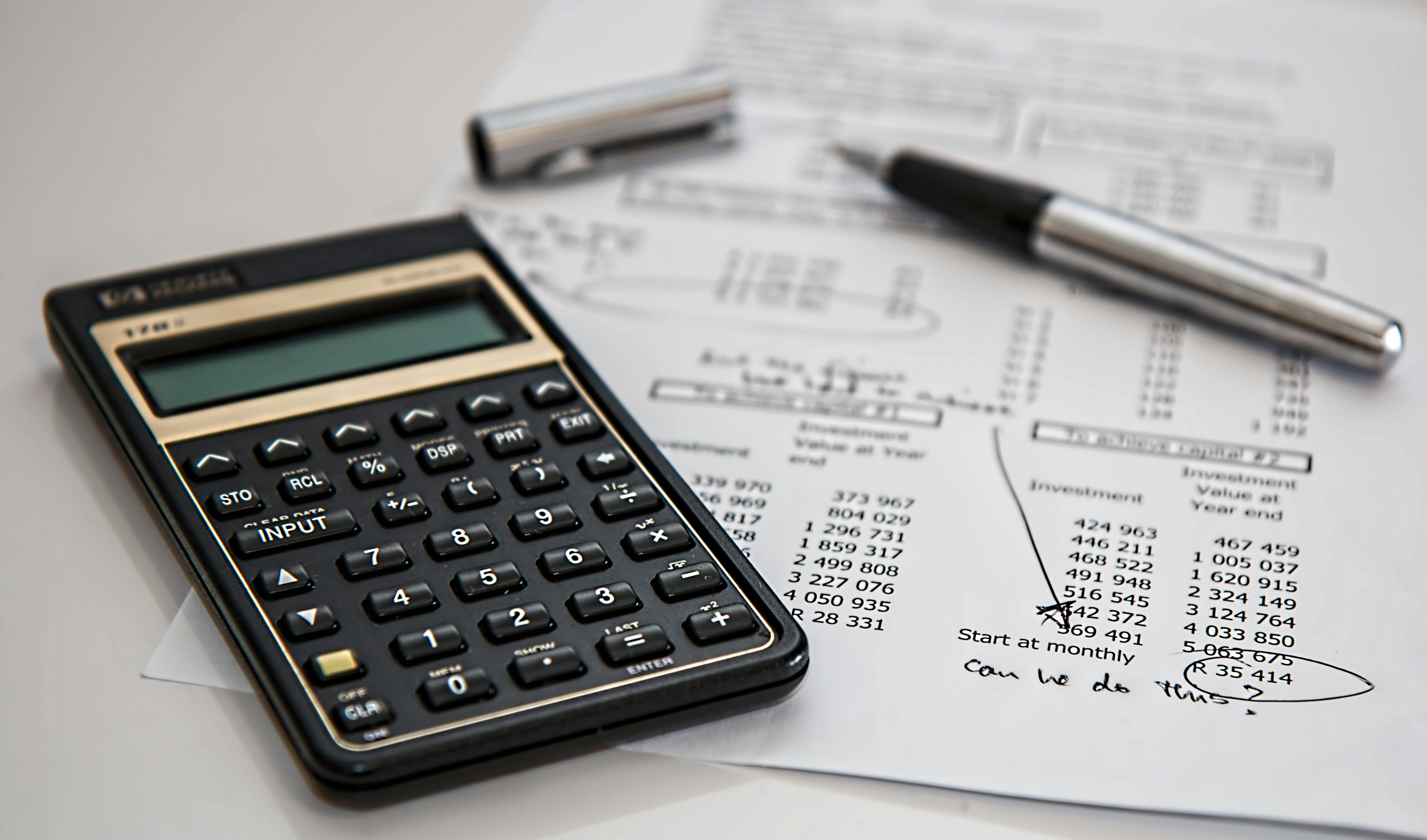 Calculator, pencil, and paper used for creating an Erasmus student budget