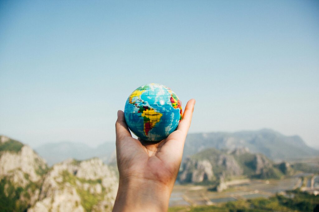 Erasmus student holding a globe symbolizing the balance between studies and travel